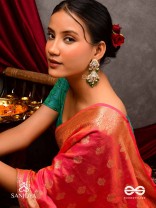 Kundalāṅgī-Kundan Elegance- Traditional pearl and Kundan earrings adorned with beads, stones, and green danglers for a regal touch.