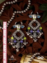 NANDI MANIKARNA- NANDI STONE EARRINGS-OXIDIZED EARRINGS FEATURING A BULL FACE, ADORNED WITH STONES AND GHUNGHROOS