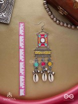 SINGHASANAMUKTA- THRONE GEM- OXIDIZED ENAMELLED EARRINGS IN MULTICOLOUR MOTIFS WITH GHUNGHROO'S AND COWRIE SHELLS