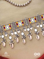  SANGRAHITAVARNA- COLLECTED HUES- ENAMELLED OXIDIZED CHOKER NECKPIECE IN PASTEL HUES WITH COWRIE SHELLS, GHUNGROOS AND MIRRORWORK