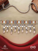  SANGRAHITAVARNA- COLLECTED HUES- ENAMELLED OXIDIZED CHOKER NECKPIECE IN PASTEL HUES WITH COWRIE SHELLS, GHUNGROOS AND MIRRORWORK