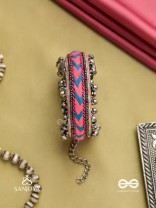 CHITRA DHARA – FLOW OF COLORS   EMBROIDERED BRACELET WITH A MIX OF COLORS AND INTRICATE THREAD WORK, ADORNED WITH GHUNGROO'S
