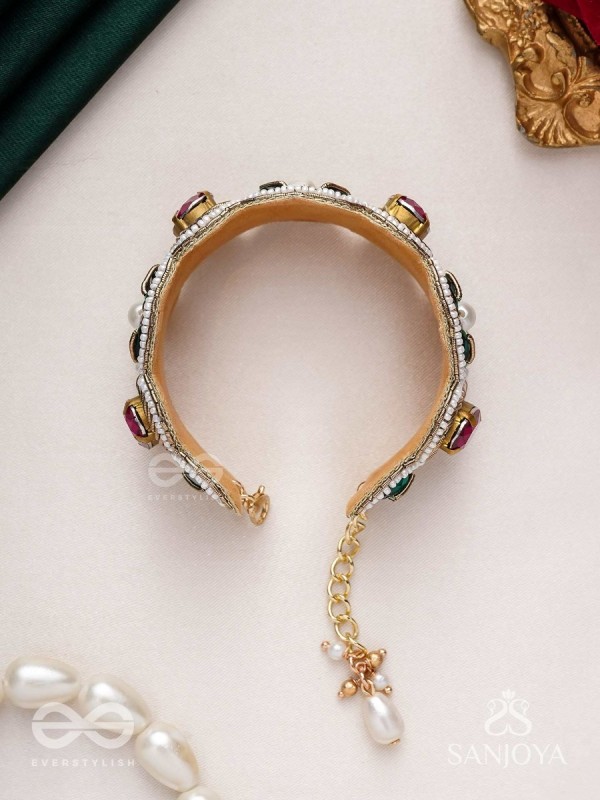 Tarangini-Wavy beauty-opulent bracelet embedded with purple and green stones