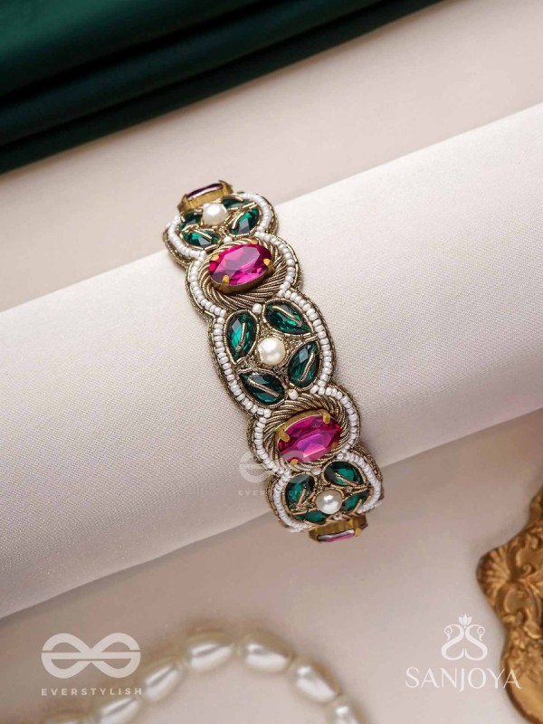 Tarangini-Wavy beauty-opulent bracelet embedded with purple and green stones