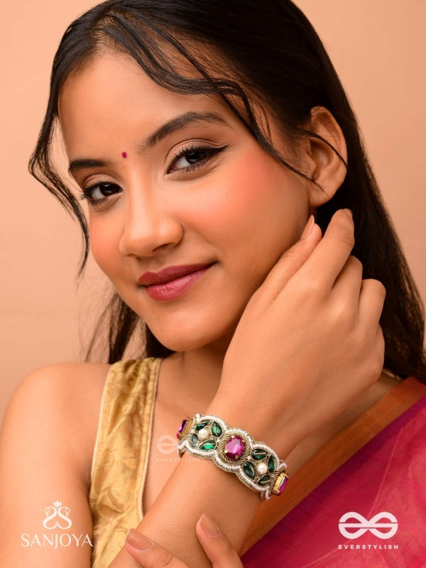 Tarangini-Wavy beauty-opulent bracelet embedded with purple and green stones