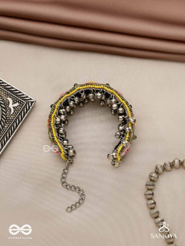SUMANALEKHA-FLORAL PATTERN- SEMI-OXIDIZED BRACELET FEATURES GHUNGROO, BEADS, AND EMBROIDERED FLOWERS