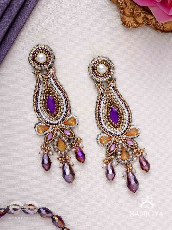 Divyaśhobhanā-Divine Splendour-Lotus-inspired embroidered design, adorned with purple and golden gem-studded motifs, Pearl and Beads.