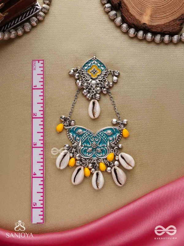 SHANKHA PUSHPA- CONCH BLOSSOM-OXIDIZED EARRINGS WITH PASTEL-HUED METALWORK, EMBELLISHED WITH DELICATE COWRIE SHELLS, YELLOW BEADS AND GHUNGROO