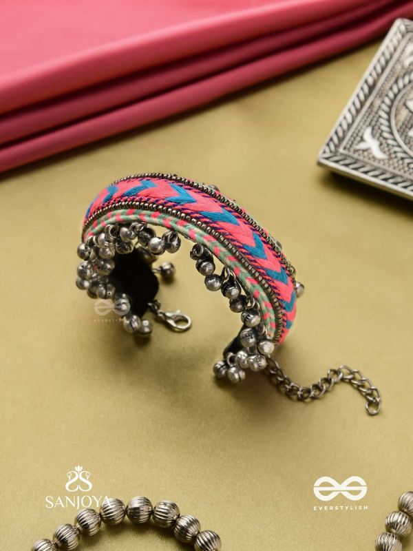 CHITRA DHARA – FLOW OF COLORS   EMBROIDERED BRACELET WITH A MIX OF COLORS AND INTRICATE THREAD WORK, ADORNED WITH GHUNGROO'S