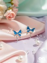FROSTY FLING – PLAYFUL BLUE BOW EARRINGS