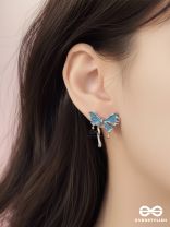 FROSTY FLING – PLAYFUL BLUE BOW EARRINGS