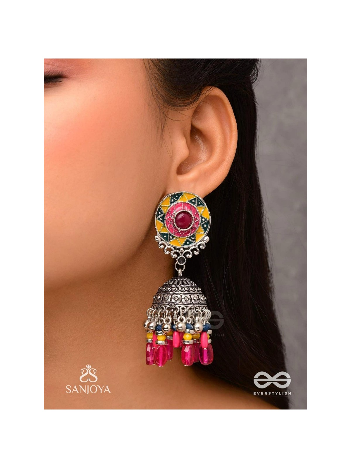 Suryaruchi-Sun's Radiance-Lavish pink earrings enamelled with a sun motif and oxidized jhumka adorned with beads and ghunghroos