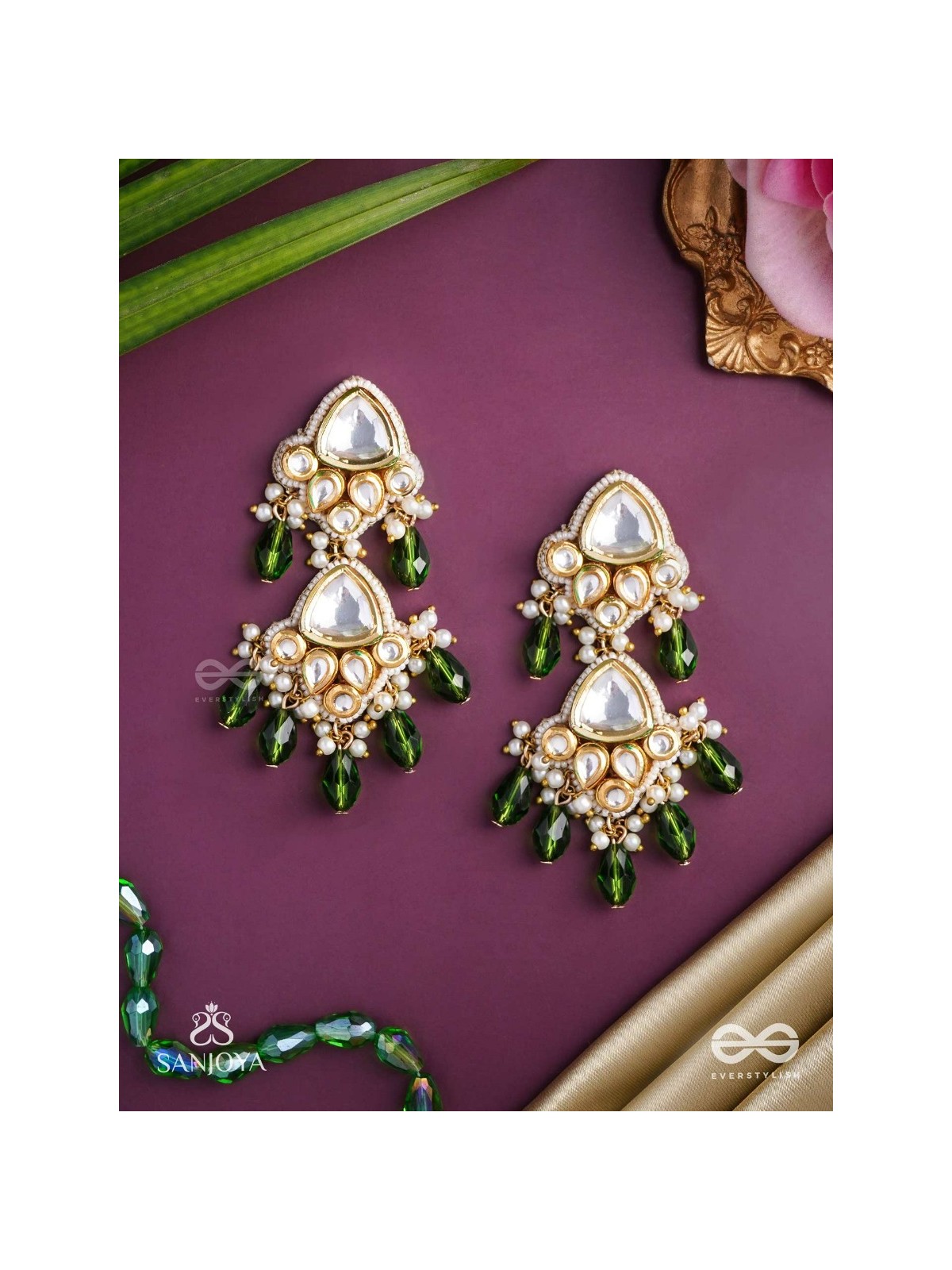 Kundalāṅgī-Kundan Elegance- Traditional pearl and Kundan earrings adorned with beads, stones, and green danglers for a regal touch.