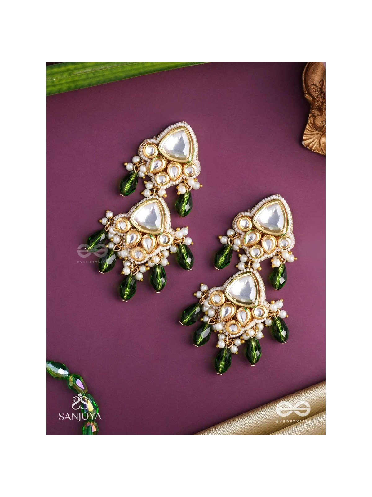 Kundalāṅgī-Kundan Elegance- Traditional pearl and Kundan earrings adorned with beads, stones, and green danglers for a regal touch.