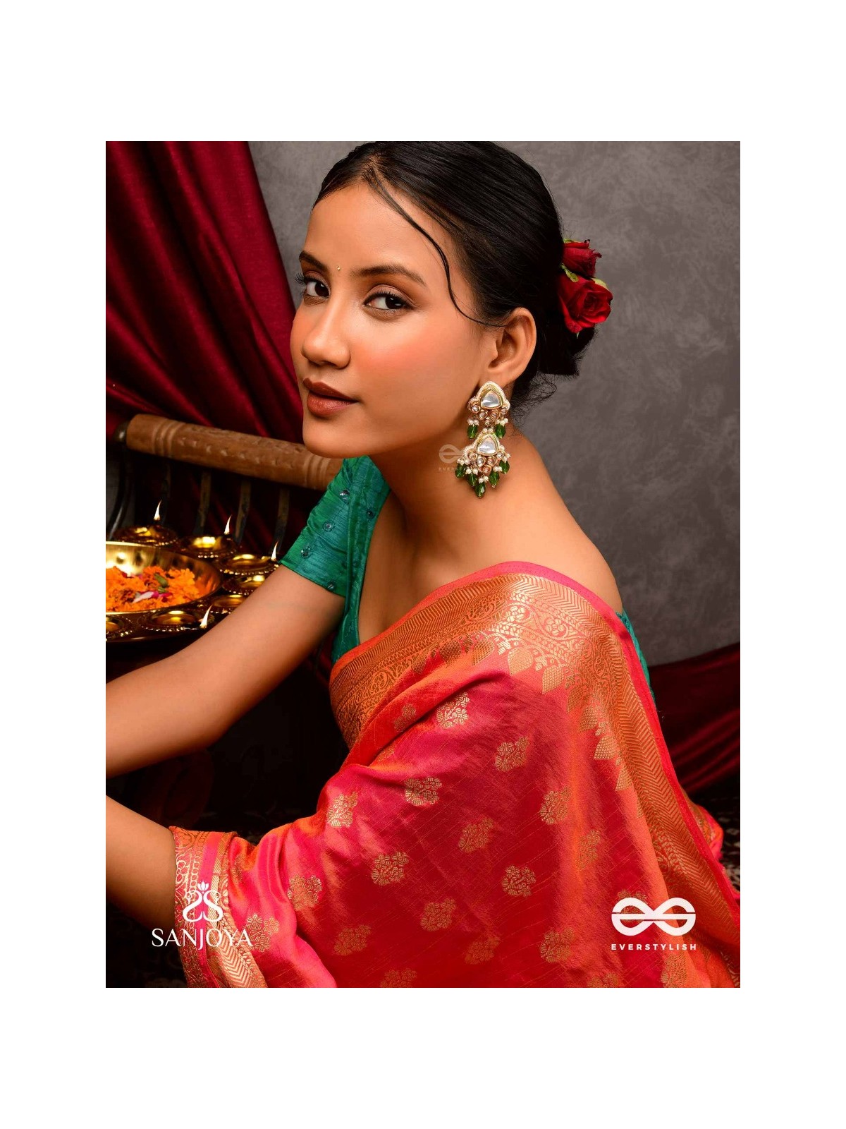 Kundalāṅgī-Kundan Elegance- Traditional pearl and Kundan earrings adorned with beads, stones, and green danglers for a regal touch.