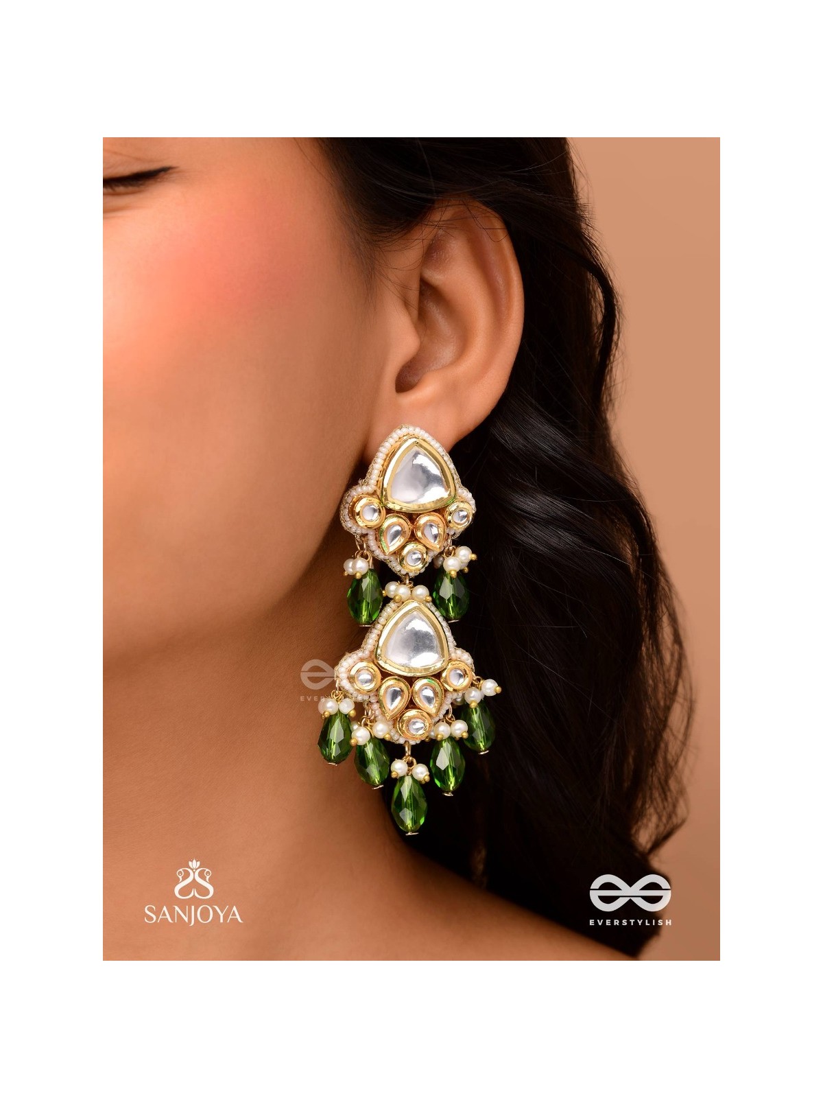 Kundalāṅgī-Kundan Elegance- Traditional pearl and Kundan earrings adorned with beads, stones, and green danglers for a regal touch.