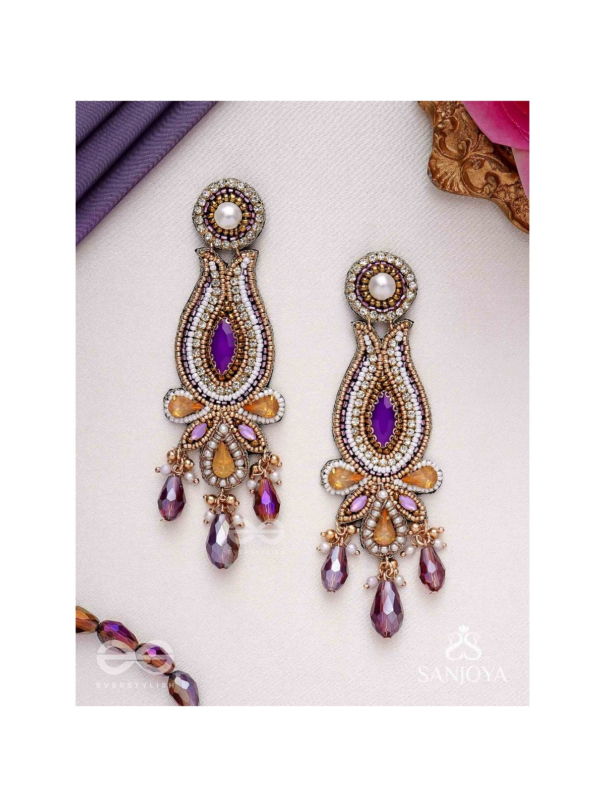 Divyaśhobhanā-Divine Splendour-Lotus-inspired embroidered design, adorned with purple and golden gem-studded motifs, Pearl and Beads.