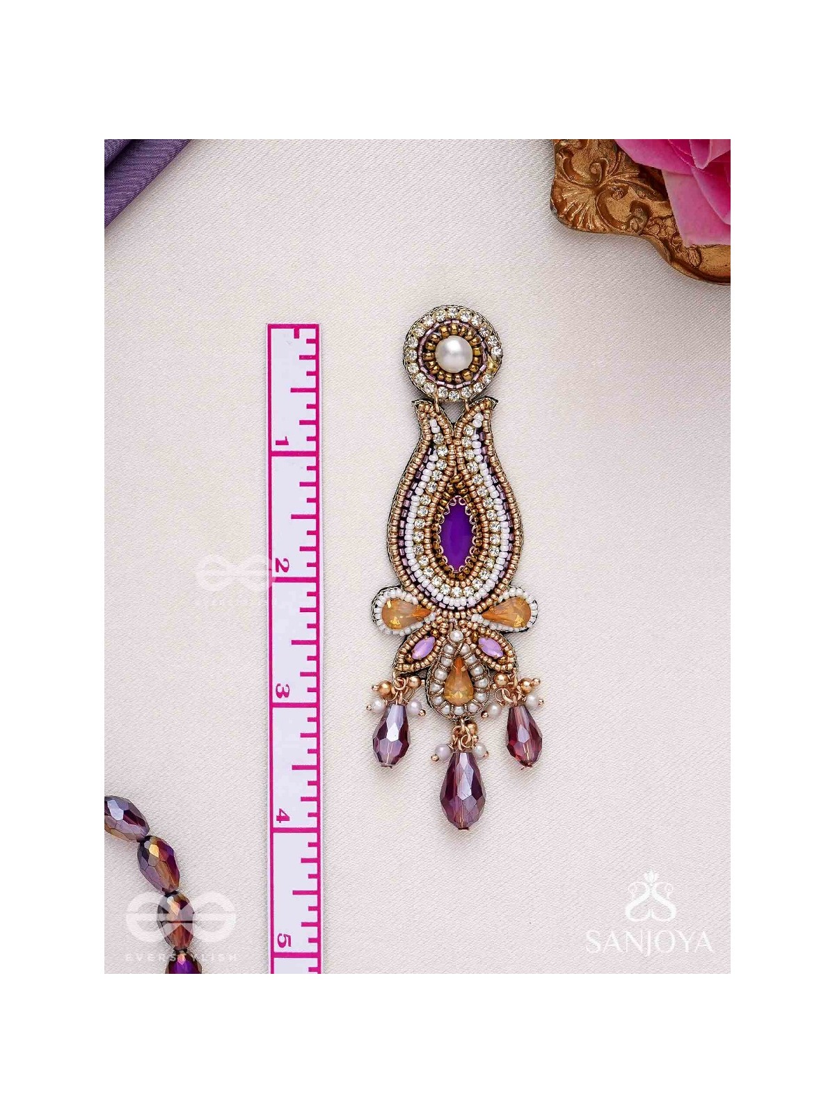 Divyaśhobhanā-Divine Splendour-Lotus-inspired embroidered design, adorned with purple and golden gem-studded motifs, Pearl and Beads.