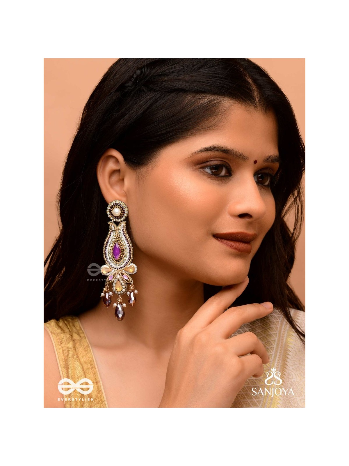 Divyaśhobhanā-Divine Splendour-Lotus-inspired embroidered design, adorned with purple and golden gem-studded motifs, Pearl and Beads.