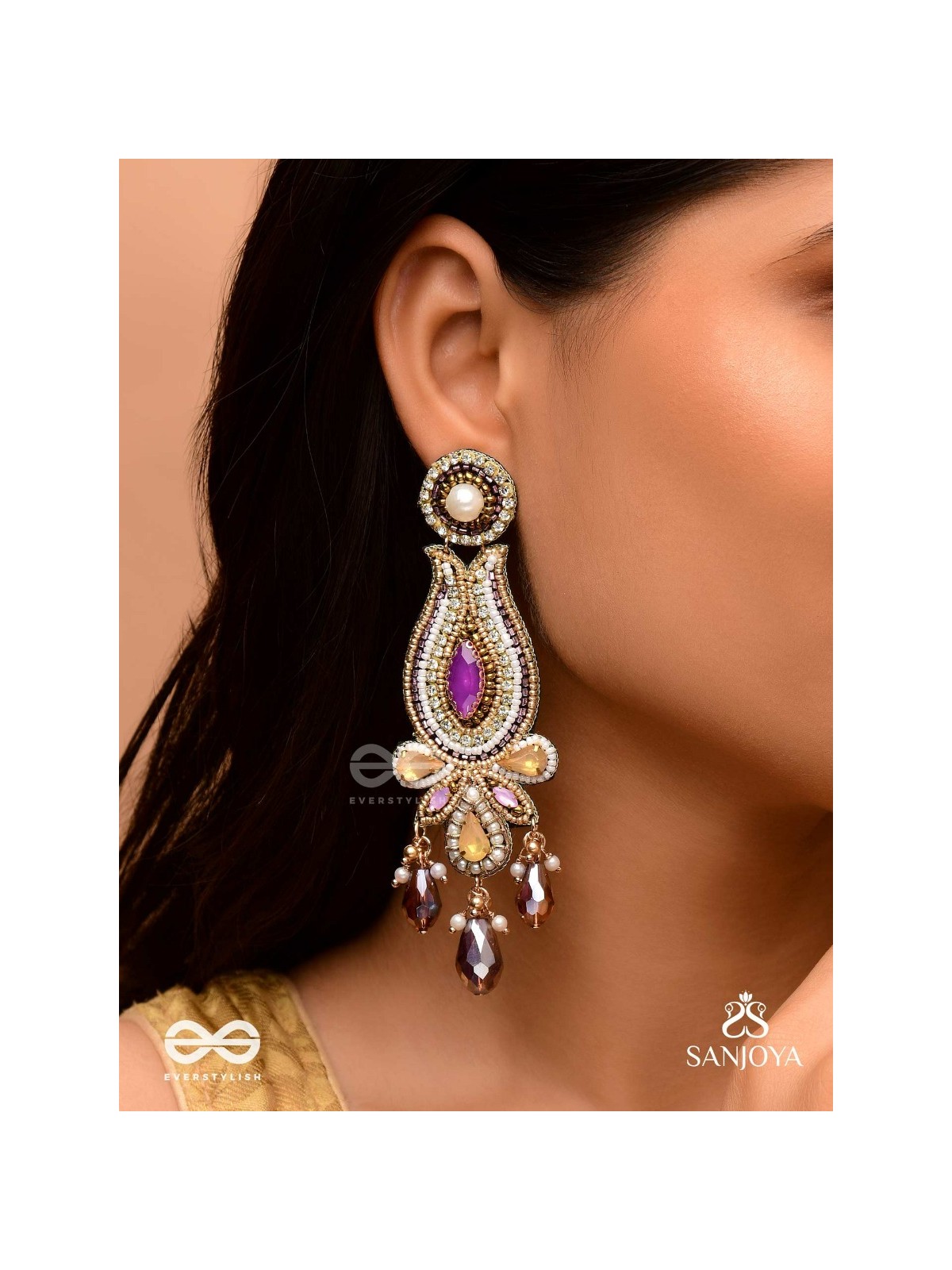 Divyaśhobhanā-Divine Splendour-Lotus-inspired embroidered design, adorned with purple and golden gem-studded motifs, Pearl and Beads.