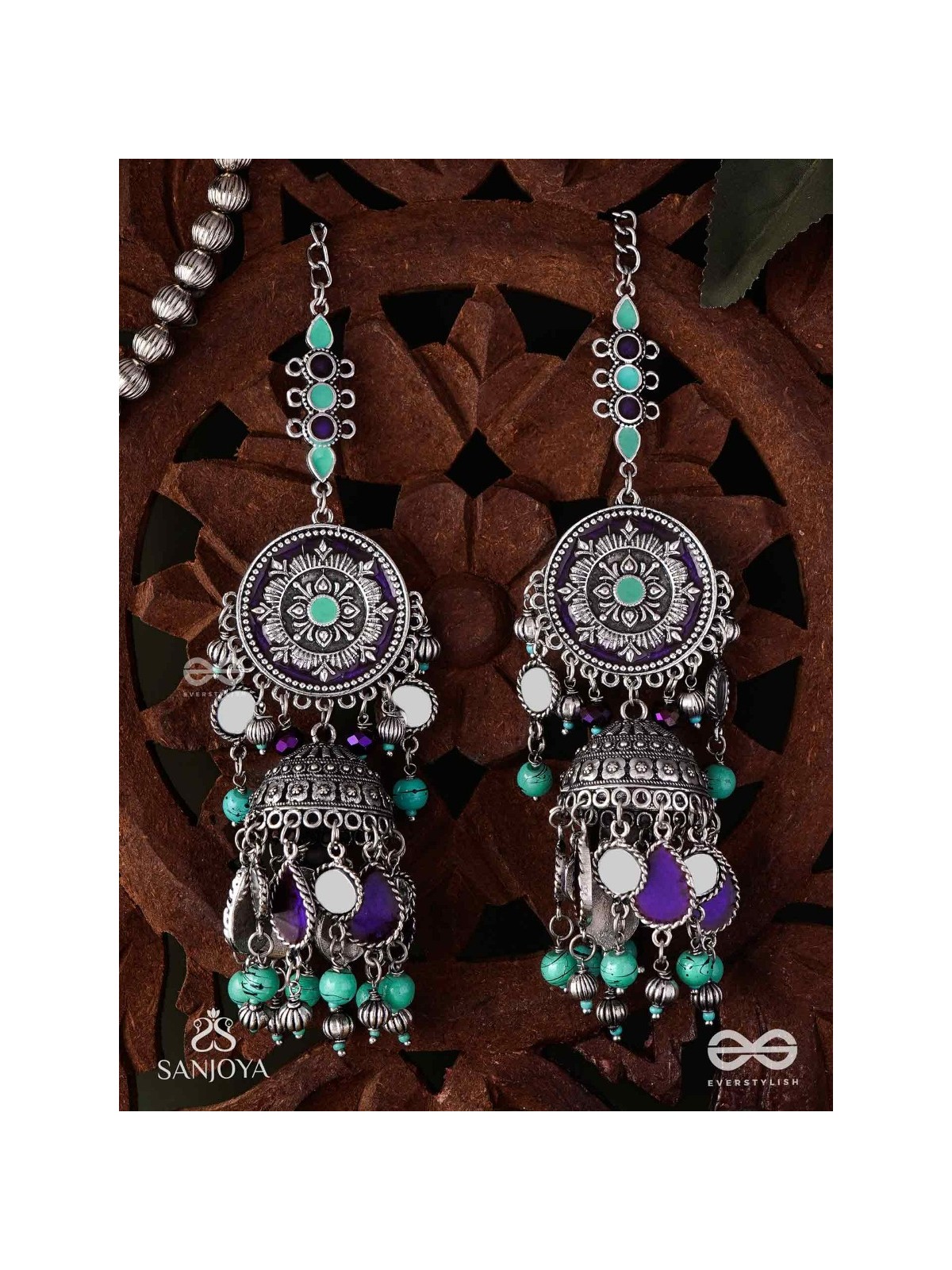 RATNA TILAKA-JEWEL ADORNMENT- EARRINGS ENAMELLED IN SHADES OF BLUE AND BLACK, ACCENTED WITH GHUNGROO BEADS AND OXIDIZED JHUMKI