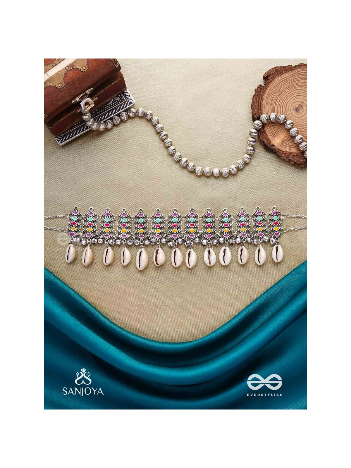 SHANKHAMALA-CONCH GARLAND- OXIDIZED NECKPIECE FEATURING PASTEL-COLOURED METALWORK, EMBELLISHED WITH DANGLING COWRIE SHELLS AND GHUNGROO'S