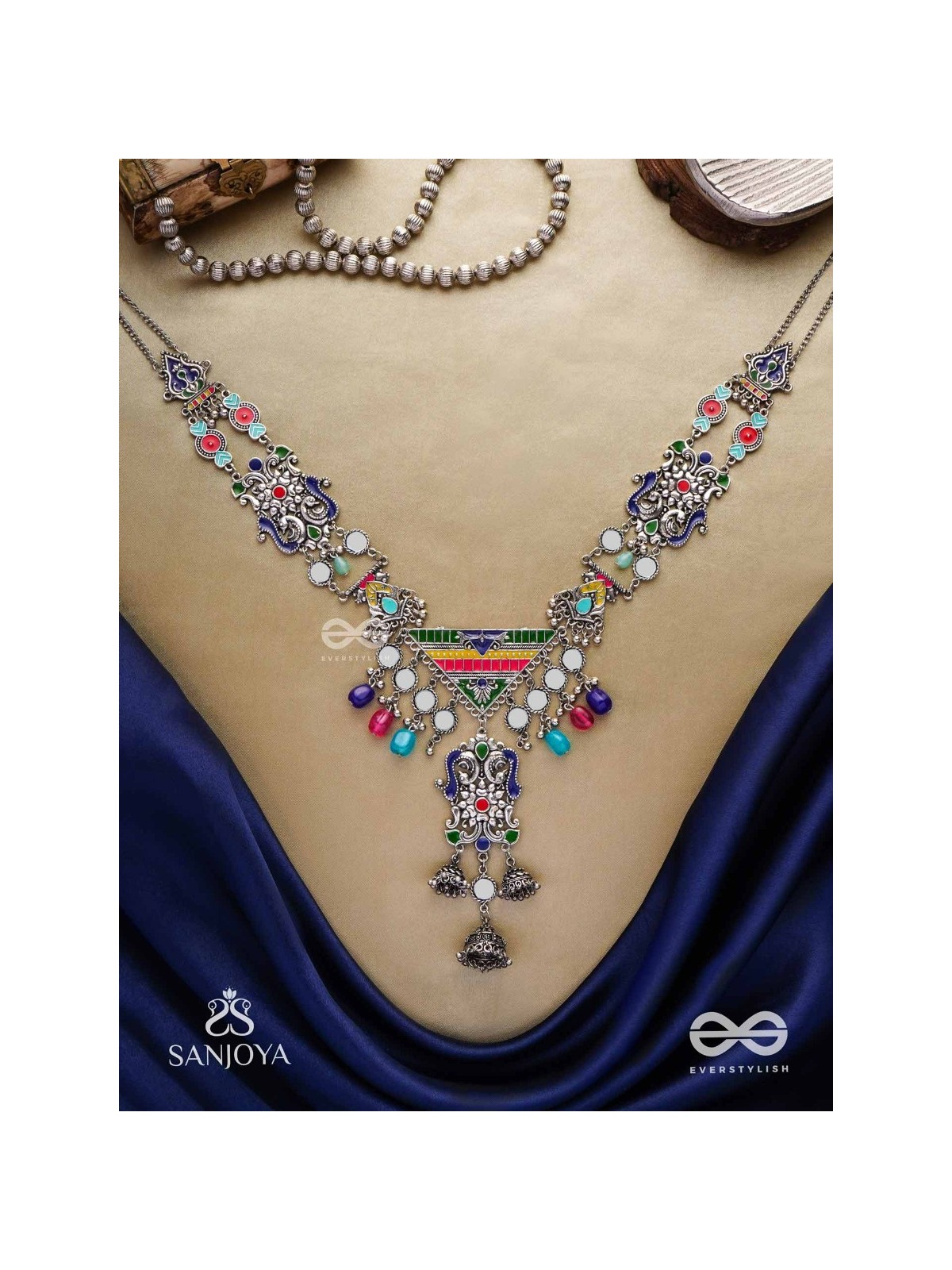 Prema raga- Love colour- Enamelled oxidized neckpiece embellished with beads, mirror and dangling jhumka.