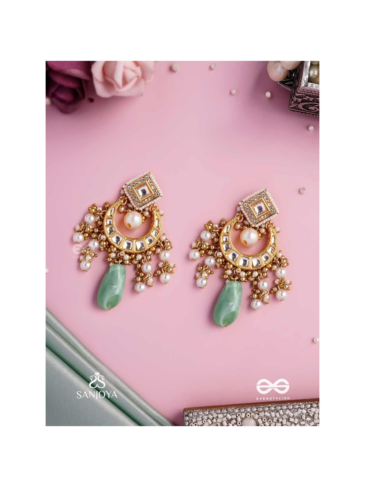 PURNIMA PHOOL – FULL MOON FLOWER AN EXQUISITE KUNDAN EARRING FEATURING GOLDEN DESIGNS, PEARL CLUSTERS, AND A GREEN GEMSTONE DROP, SYMBOLIZING ELEGANCE