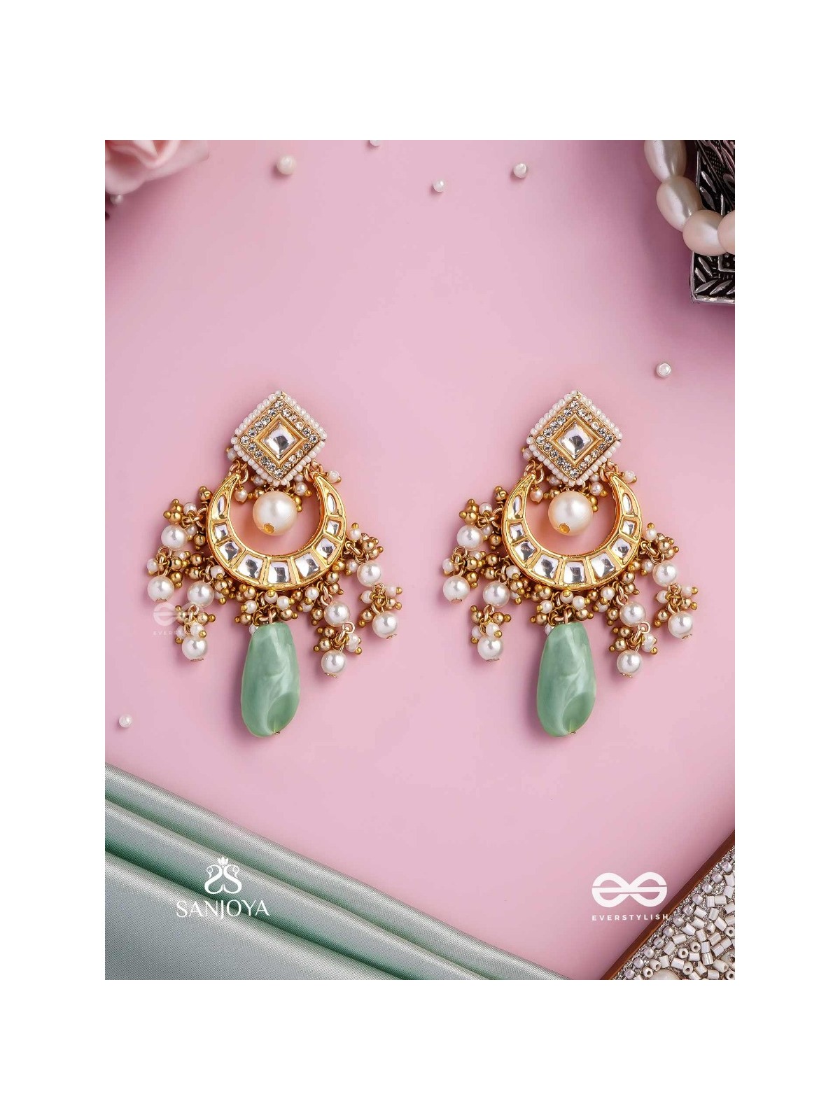 PURNIMA PHOOL – FULL MOON FLOWER AN EXQUISITE KUNDAN EARRING FEATURING GOLDEN DESIGNS, PEARL CLUSTERS, AND A GREEN GEMSTONE DROP, SYMBOLIZING ELEGANCE